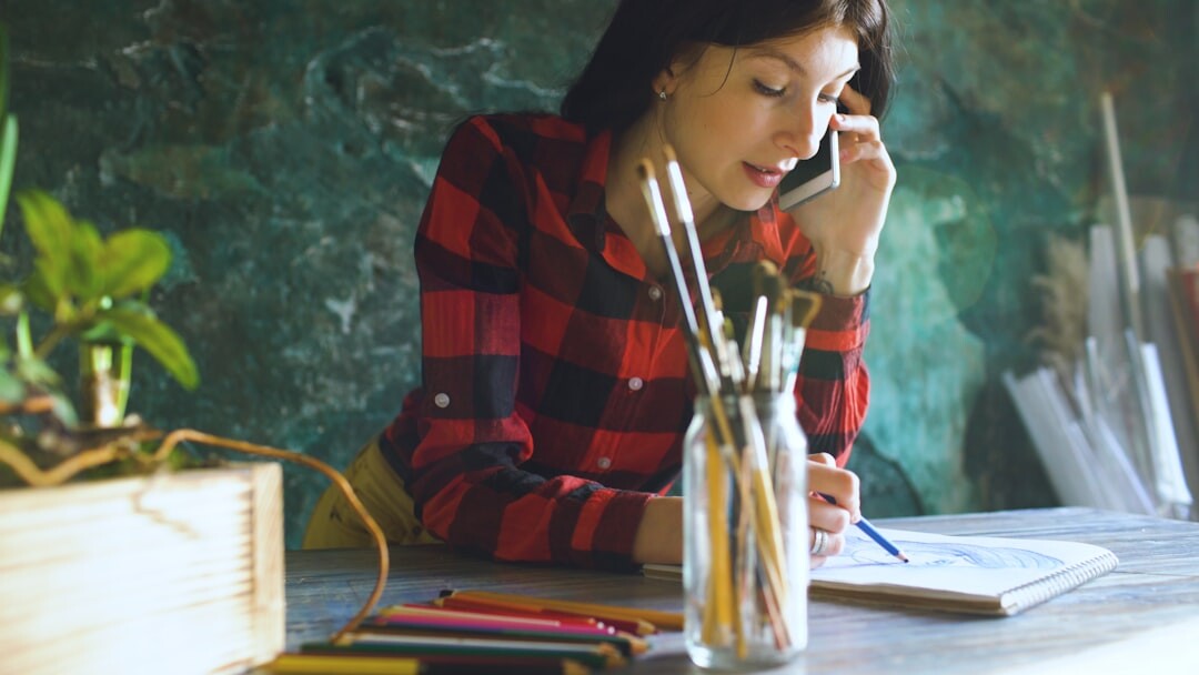writer sitting at desk with pen and paper